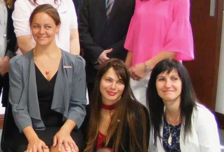 Clinical Supervisor Titta Laattala with two of the 2020 graduates